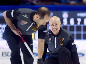 Skip Kevin Koe, of Calgary, watches second Brent Laing sweep his rock earlier this week. (THE CANADIAN PRESS)