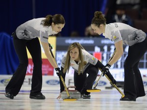 Rachel Homan watches her shot as Joanne Courtney (right) and Lisa Weagle sweep during the Canadian Olympic trials at the Canadian Tire Centre on Sunday. (The Canadian Press)