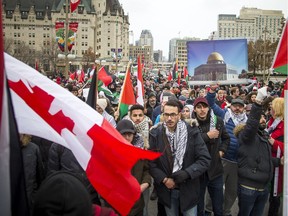 Supporters gathered outside the US Embassy then marched to the Embassy of Israel on O'Connor Street Saturday December 9, 2017.   Canadians for Justice and Peace in the Middle East (CJPME) opposes the US Trump government's decision to recognize Jerusalem as Israel's capital, and begin the process of relocating its embassy to Jerusalem. Like many Canadians, CJPME strongly believes that the world's governments should not recognize Jerusalem as Israel's capital until Israel has reached a just peace settlement with the Palestinians.    Ashley Fraser/Postmedia