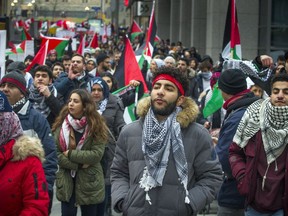 Supporters gathered outside the US Embassy then marched to the Embassy of Israel on O'Connor Street Saturday December 9, 2017.   Canadians for Justice and Peace in the Middle East (CJPME) opposes the US Trump government's decision to recognize Jerusalem as Israel's capital, and begin the process of relocating its embassy to Jerusalem. Like many Canadians, CJPME strongly believes that the world's governments should not recognize Jerusalem as Israel's capital until Israel has reached a just peace settlement with the Palestinians.    Ashley Fraser/Postmedia