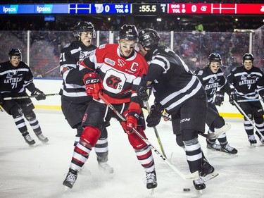 Ottawa 67's #19 Travis Barron battles for the puck against the Gatineau Olympiques during the outdoor game at TD Place for an outdoor game Sunday December 17, 2017.   Ashley Fraser/Postmedia