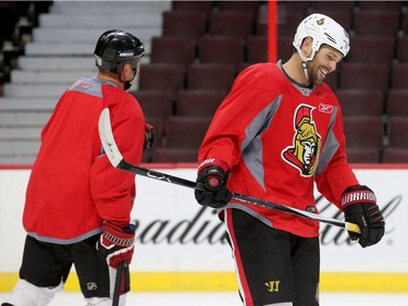 Mike Fisher yuks it up on the ice with some former teammates.