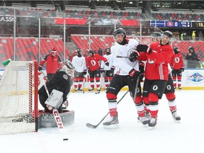 Mike Hoffman (R) and Cody Ceci of the Ottawa Senators collide and laugh it off during practice on the outdoor rink at TD Place in Ottawa, December 10, 2017.
