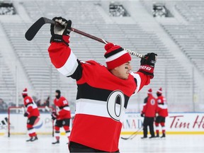 Jean-Gabriel Pageau  of the Ottawa Senators stretches during morning practice on the outdoor rink at TD Place,