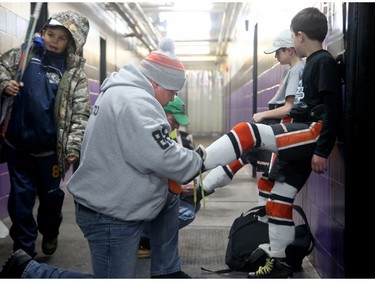 A familiar sight at the Minto Arena as Philadelphia dad Bob Cattalo laces up his son Bobby's skates in the hallway ahead.
