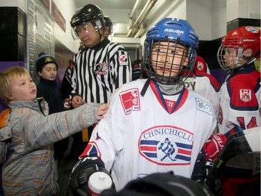 A boy reaches out to congratulate the Chunichi team from Japan as they came off the ice after their close 4-3 to the Osgoode Romans.