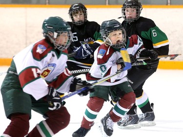 Aarvala Taavi (centre), from Finnish team Karhu-Kissat, gets ahead of the pack to take control of the puck during a Bell Capital Cup game against the Leitrim Hawks on Thursday, Dec. 28, 2017.