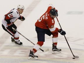 Florida Panthers' Aaron Ekblad moves the puck as Ottawa Senators' Ryan Dzingel defends during Saturday night's game. (AP PHOTO)