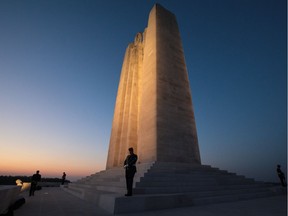 Members of the Canadian armed forces stand on the Canadian National Vimy Memorial during a night-time vigil following a Sunset Ceremony on April 8, 2017 in Vimy, France.