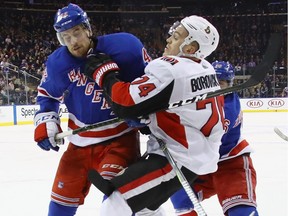 Brendan Smith #42 of the New York Rangers takes a five minute major and a game misconduct for his interference on Mark Borowiecki #74 of the Ottawa Senators on November 19, 2017 in New York City.