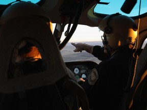 U.S. Customs and Border Protection (CBP) pilots fly over the Big Bend sector of west Texas on November 22, 2017 near Van Horn, Texas. Federal agents are searching for suspects in the death of U.S. Border Patrol agent Rogelio Martinez, 36, and a fellow agent who was severely injured while responding to "activity" near Van Horn.