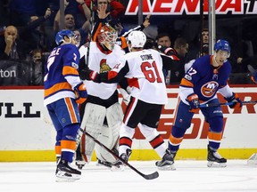 NEW YORK, NY - DECEMBER 01:  Mark Stone #61 and Mike Condon #1 of the Ottawa Senators celebrate their 6-5 victory over the New York Islanders at the Barclays Center on December 1, 2017 in the Brooklyn borough of New York City.