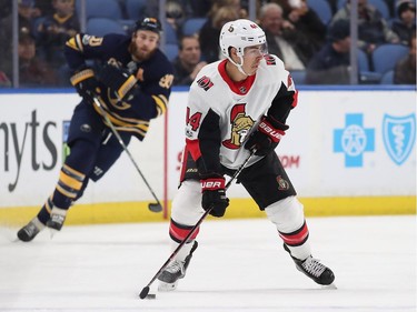 Jean-Gabriel Pageau #44 of the Ottawa Senators with the puck as Ryan O'Reilly #90 of the Buffalo Sabres pursues during the first period at the KeyBank Center on December 12, 2017 in Buffalo, New York.