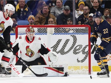 Mike Condon #1 of the Ottawa Senators tends net as Johan Larsson #22 of the Buffalo Sabres looks for the rebound during the first period at the KeyBank Center on December 12, 2017 in Buffalo, New York.