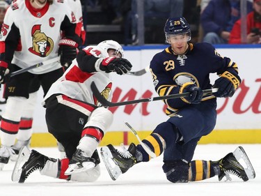 Jason Pominville #29 of the Buffalo Sabres tries to tip a shot as Alexandre Burrows #14 of the Ottawa Senators defends during the first period at the KeyBank Center on December 12, 2017 in Buffalo, New York.