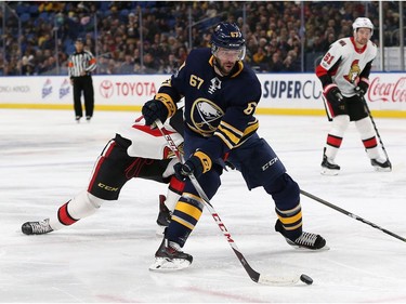 Benoit Pouliot #67 of the Buffalo Sabres scores a goal on this back hand shot during the second period against the Ottawa Senators at the KeyBank Center on December 12, 2017 in Buffalo, New York.