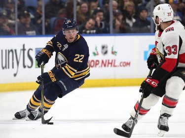 Johan Larsson #22 of the Buffalo Sabres skates up ice with the puck as Fredrik Claesson #33 of the Ottawa Senators defends during the second period at the KeyBank Center on December 12, 2017 in Buffalo, New York.