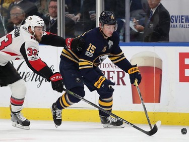 Jack Eichel #15 of the Buffalo Sabres with the puck as Fredrik Claesson #33 of the Ottawa Senators pursues during the second period at the KeyBank Center on December 12, 2017 in Buffalo, New York.