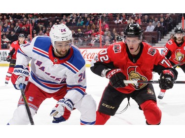 The Senators' Thomas Chabot battles for the loose puck against Boo Nieves.