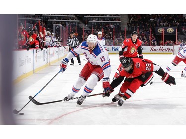 The Rangers' Kevin Hayes tries to go outside on the Senators' Johnny Oduya.