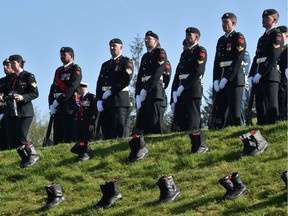 Soldiers stand next to boots dropped off the lawn, during a commemoration ceremony at the Canadian National Vimy Memorial in Vimy, near Arras, northern France, on April 9, 2017, marking the 100th anniversary of the Battle of Vimy Ridge, a World War I battle which was a costly victory for Canada, but one that helped shape the former British colony's national identity.