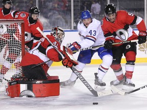 Senators goalie Craig Anderson turns away a shot as the Canadiens' Daniel Carr is held up by Cody Ceci in the second period of the NHL 100 Classic outdoor hockey game at TD Place in Ottawa on Saturday night.  (Wayne Cuddington/ Postmedia Network)