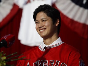 Shohei Ohtani smiles during a news conference at Angel Stadium on Saturday.