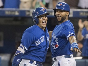 The Blue Jays' Ryan Goins, left, celebrates a grand-slam against the Yankees on Sept. 22.