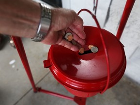 HALLANDALE, FL - NOVEMBER 28:  A donation is made into a Salvation Army  red kettle on Giving Tuesday on November 28, 2017 in Hallandale, Florida.  Giving Tuesday is a single day following the heavy Thanksgiving shopping period specifically focused on charity.  (Photo by Joe Raedle/Getty Images) ORG XMIT: 775084606