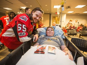 Erik Karlsson visits with Nikolas Boissonnault as the Ottawa Senators make their annual holiday visit to CHEO to bring a little cheer into the lives of patients, their parents and a few of the staff at the childrens hospital.