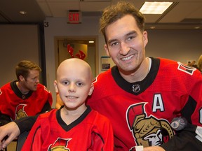 Joshua Crawford and Mark Stone pose for a photo as the Ottawa Senators make their annual holiday visit to CHEO to bring a little cheer into the lives of patients, their parents and a few of the staff at the childrens hospital.