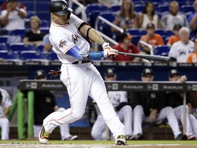 Marlins' Giancarlo Stanton hits a two-run home run during the first inning of a game against the Giants in Miami on Aug. 14, 2017.