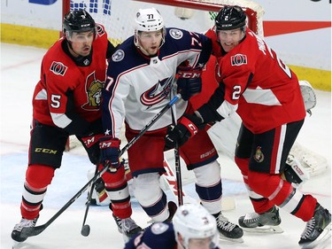 Ottawa defencemen Cody Ceci (5) and teammate Dion Phaneuf stick close to Columbus forward Josh Anderson in front of the net in the third period.