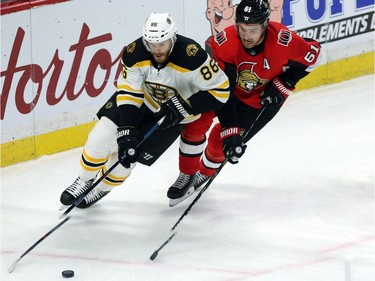 Ottawa's Mark Stone (61) chases down Boston's Kevan Miller (86) as he skates with the puck in the first period.