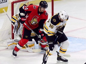 Bruins defenceman Kevan Miller (86) blocks a shot as Senators forward Alex Burrows (14) looks on during first-period play against Boston on December 30, 2017.