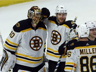 Boston goalie Tuukka Rask (40) celebrates his 5-0 shutout with teammates after time runs out on the Senators on Saturday night.