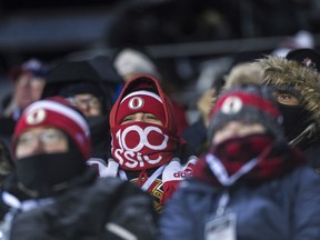 An Ottawa Senators fan looks on before hockey action against the Montreal Canadiens at the NHL 100 Classic, in Ottawa on Saturday, December 16, 2017.