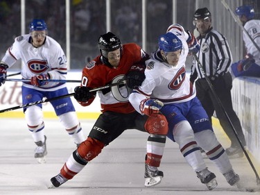 Montreal Canadiens centre Byron Froese (42) and Ottawa Senators centre Gabriel Dumont (40) battle on the boards during third period hockey action at the NHL 100 Classic, in Ottawa on Saturday, December 16, 2017.