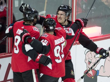 The Senators' Mark Stone (61) and centre Matt Duchene (95) congratulate teammate Bobby Ryan.