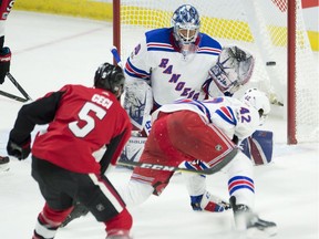 New York Rangers goalie Henrik Lundqvist is screened by defenceman Brendan Smith (42) as Ottawa Senators defenceman Cody Ceci shoots the puck into the net during the second period.
