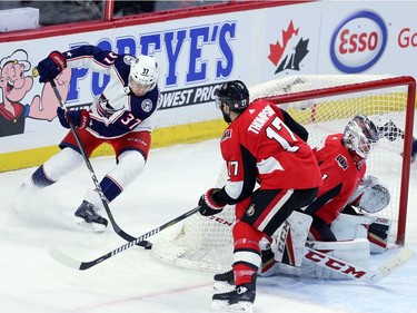 Senators centre Nate Thompson (17) tries to cut off the Blue Jackets' Markus Hannikainen (37) as he attempts a wrap around attack on the goal of Senators netminder Mike Condon in the second period.