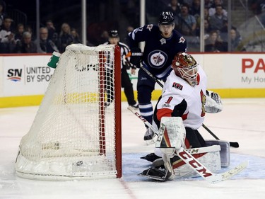 Winnipeg Jets' Mark Scheifele (not shown) scores against Ottawa Senators goaltender Mike Condon (1) during first period NHL hockey action in Winnipeg, Sunday, December 3, 2017.