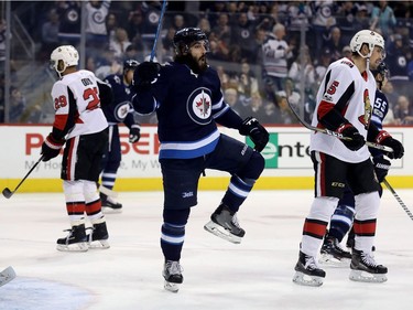 Winnipeg Jets' Mathieu Perreault (85) celebrates after scoring against the Ottawa Senators during first period NHL hockey action in Winnipeg, Sunday, December 3, 2017.