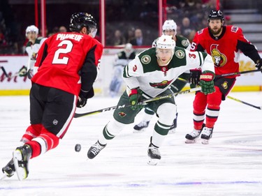 Minnesota Wild's Charlie Coyle attempts to move the puck past Ottawa Senators' Dion Phaneuf during first period NHL hockey action in Ottawa on Tuesday, Dec. 19, 2017.
