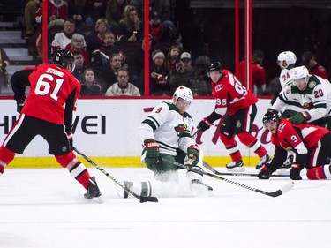 Minnesota Wild's Mikko Koivu attempts to block a shot from Ottawa Senators' Mark Stone during first period NHL hockey action in Ottawa on Tuesday, Dec. 19, 2017.