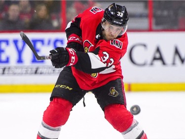 Ottawa Senators' Fredrik Claesson dumps the puck while taking on the Minnesota Wild during second period NHL hockey action in Ottawa on Tuesday, Dec. 19, 2017.