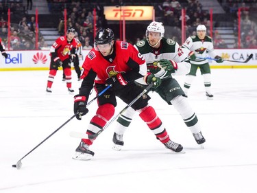 Ottawa Senators' Bobby Ryan moves the puck past Minnesota Wild's Jonas Brodin during second period NHL hockey action in Ottawa on Tuesday, Dec. 19, 2017.