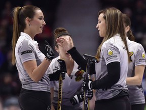 Skip Rachel Homan high-fives third Emma Miskew during a draw against Team Homan on Dec. 8, 2017