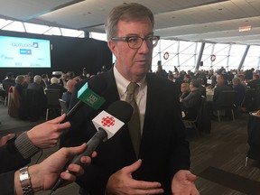 Mayor Jim Watson defended the city’s proposed two-per-cent property tax increase in a scrum with reporters Thursday after his annual economic speech at the Shaw Centre. Jon Willing/Postmedia