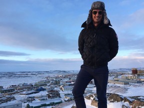 NACO musical director Alexander Shelley stands on a bluff above Iqaluit, where the orchestra stopped earlier this week on the final leg of its Canada 150 cross-country tour.